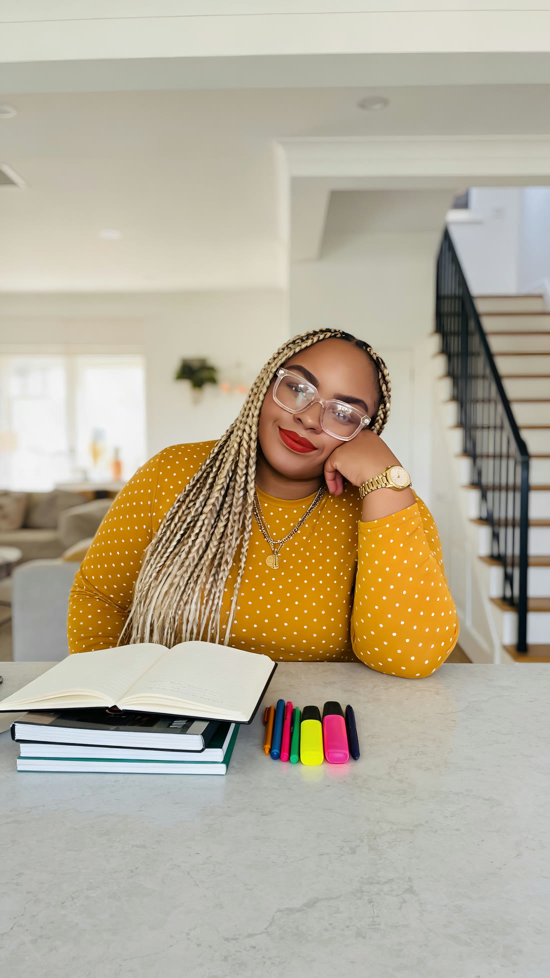 Tomi at a counter with notebooks and highlighters laid out